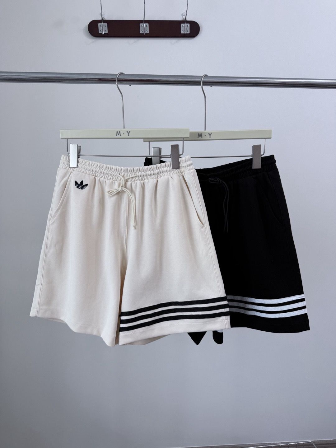 Adidas Originals Adicolor Neuclassics shorts in wonder white with black stripes.